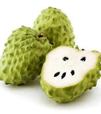 Green African Pride atemoya fruit cut open showing white flesh and black seeds