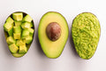 Hass avocado cut open to show its flesh and seed displayed cubed and as guacamole 