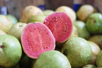 Pink Indian guava cut open to show its reddish flesh