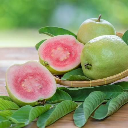 Ruby Supreme guava cut open to show its pink flesh
